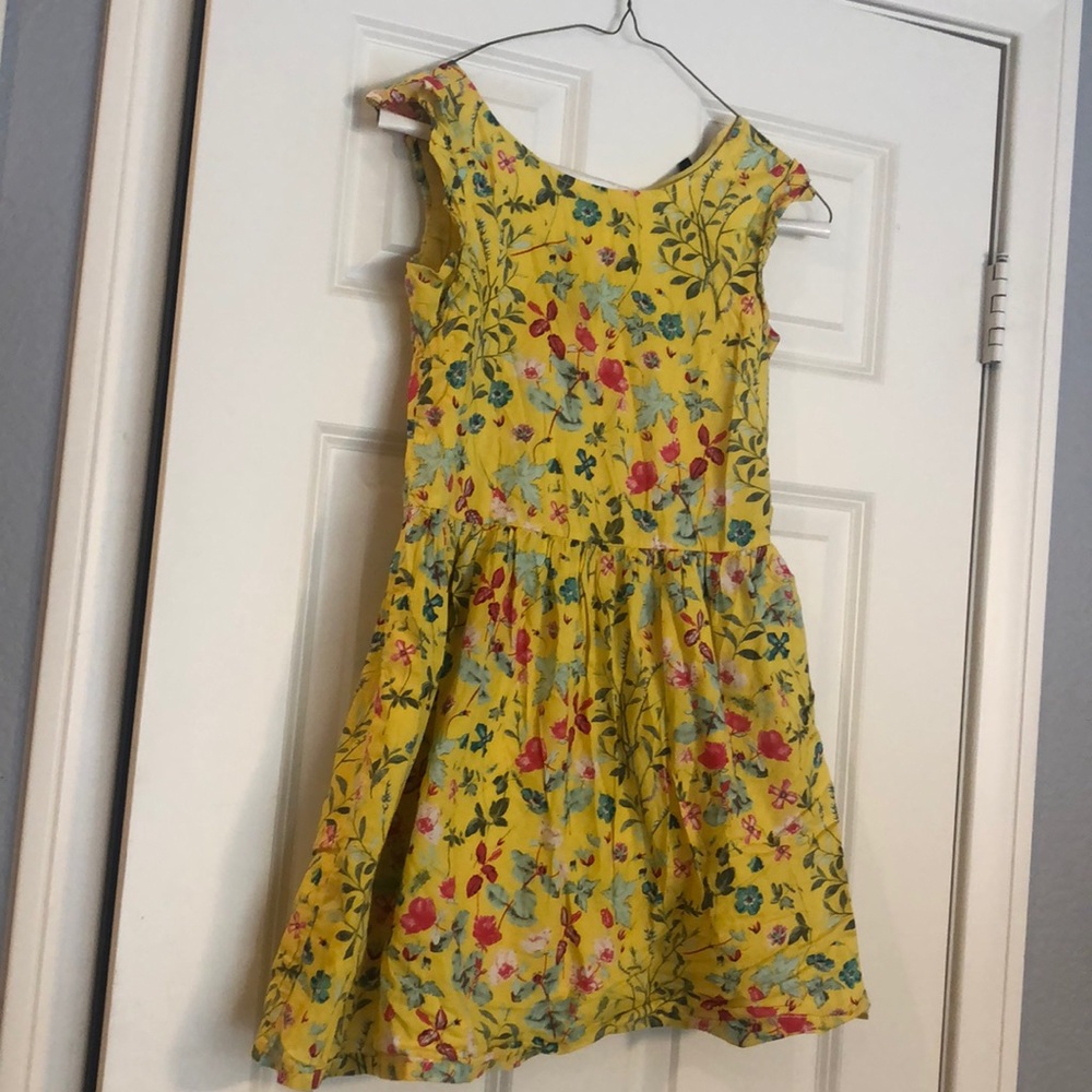 Knee-length dress. Yellow with pink/blue flowers.